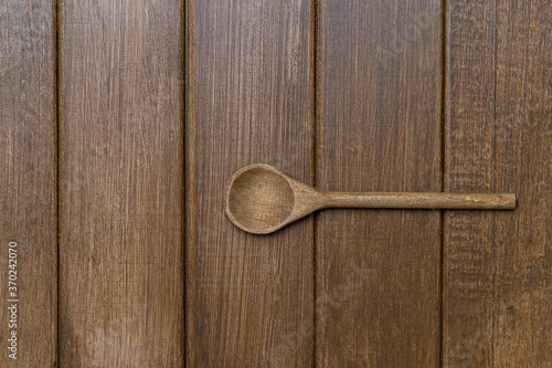 Wooden spoon on wood background. Natural kitchen tools wood product. Zero waste concept.