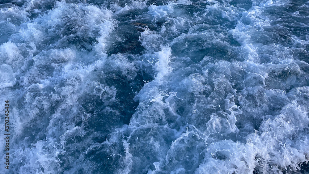 Seawater Ocean surface, sea foam on the blue ocean, background.