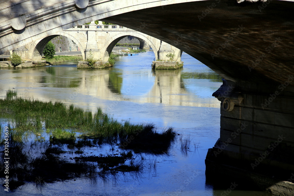 Bridges, arches and reflection on the river, Rome, Italy