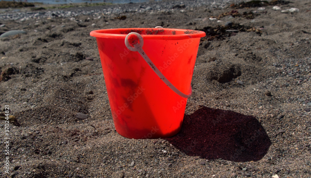 Beach toys on a bright sunny day, not new toys that have been played with.