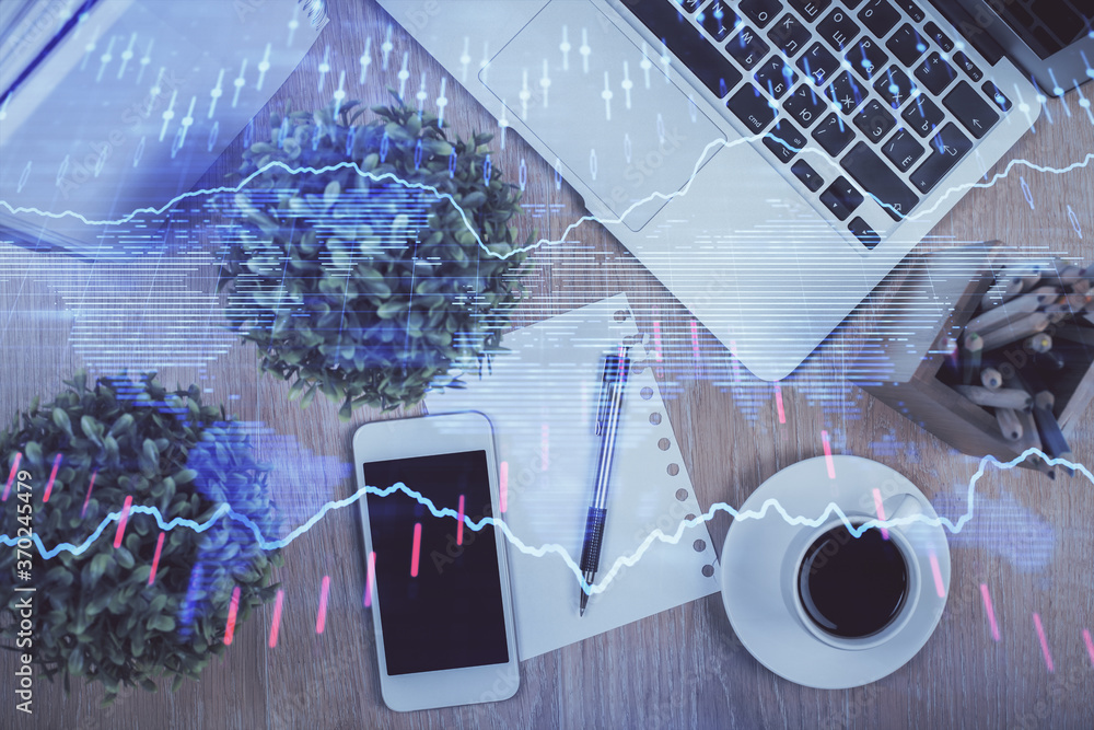 Multi exposure of financial chart hologram over desktop with phone. Top view. Mobile trade platform concept. Multi exposure of financial chart hologram over desktop with phone. Top view. Mobile trade platform concept.