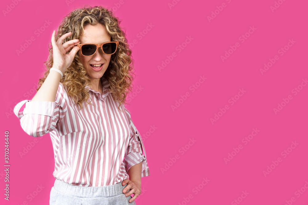 Fototapeta premium Portrait of a young, beautiful, healthy woman holding glasses and looking at the camera.