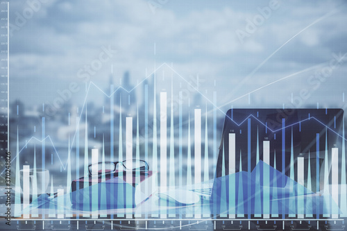 Double exposure of financial chart drawings and desk with open notebook background. Concept of forex market