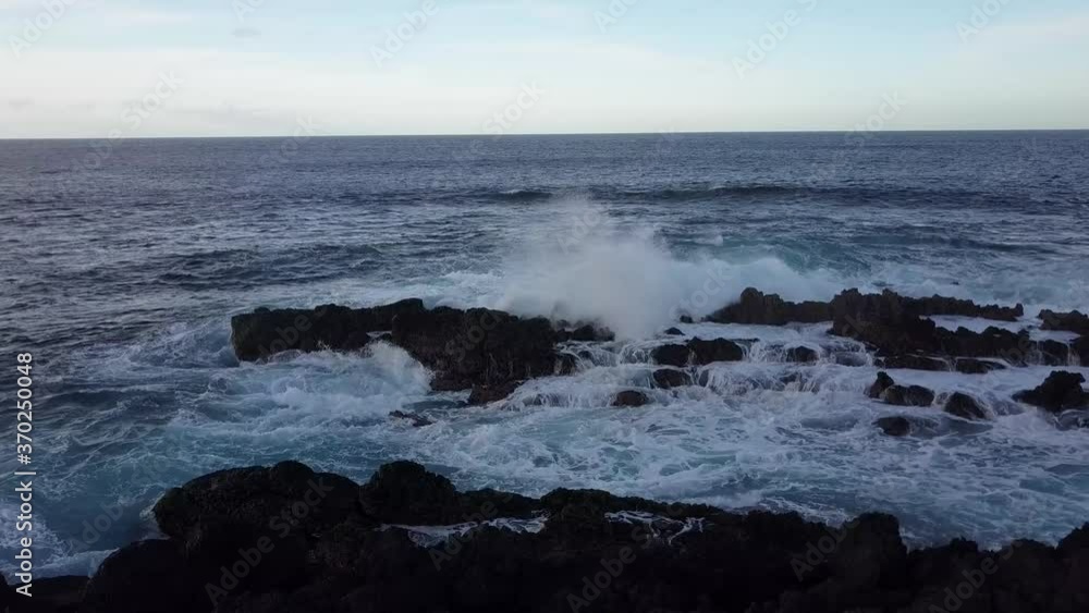 Aerial Dolly Shot of Waves Crashing Against Volcanic Rocks Aerial Dolly Shot of Waves Crashing Against Volcanic Rocks