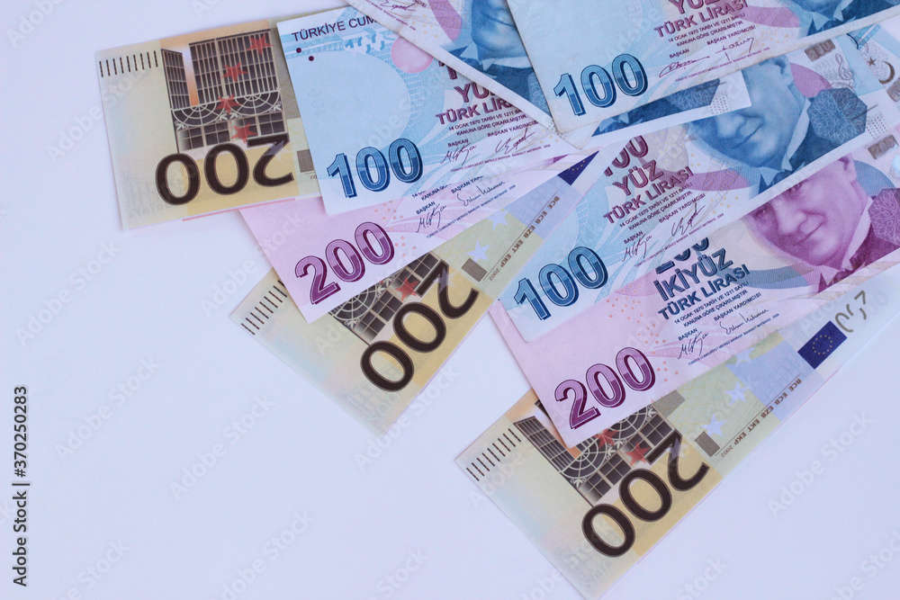 Turkish Banknotes and Two Hundred Euro Banknotes designed together on white surface with copy space Turkish Banknotes and Two Hundred Euro Banknotes designed together on white surface with copy space