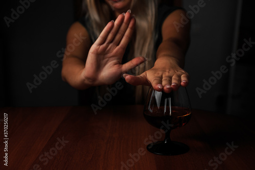 Young woman alcoholic social problems concept sitting refusal of alcohol