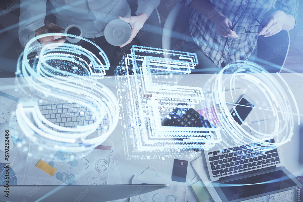 Double exposure of man and woman working together and SEO hologram drawing. Search engine concept. Computer background. Top View. Double exposure of man and woman working together and SEO hologram drawing. Search engine concept. Computer background. Top View.