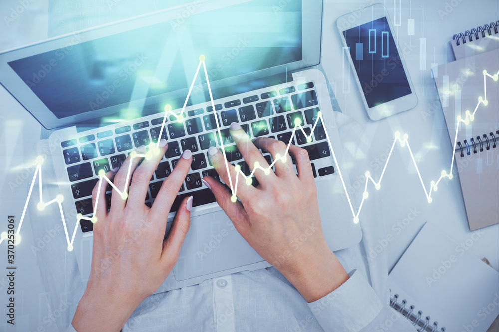 Double exposure of woman hands working on computer and forex chart hologram drawing. Top View. Financial analysis concept. Double exposure of woman hands working on computer and forex chart hologram drawing. Top View. Financial analysis concept.