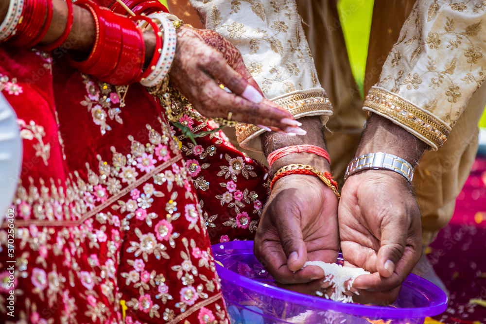 Indian Hindu wedding ceremony ritual items, hands and decorations close up
