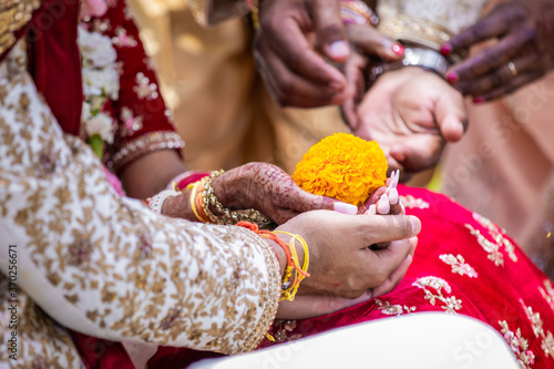Indian Hindu wedding ceremony ritual items, hands and decorations close up © Stella Kou