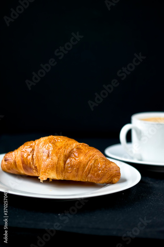 A fresh croissant with morning coffee