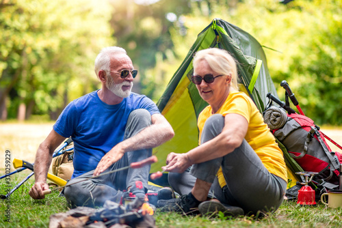 Senior couple camps in the forest