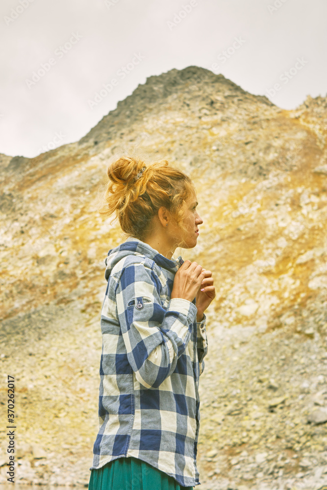 Naklejka premium Young Caucasian woman traveling in the mountains of Bulgaria. Near Mount Vihren.