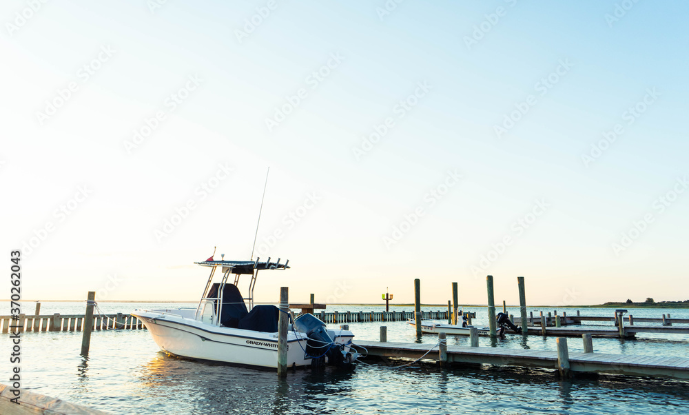 Fototapeta premium Sunset background with boats docked in the harbor, Long Beach Island vacation destination