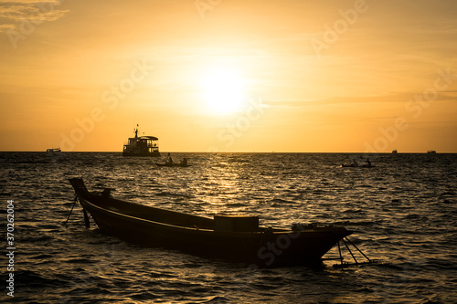 Sunset on the beach with long tail boat