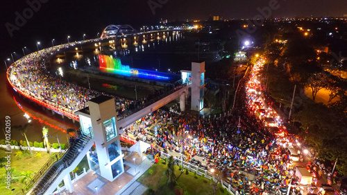 Aerial view of nighttime fountain attraction at Surabaya bridge, East Java, Indonesia which attracts local tourists

