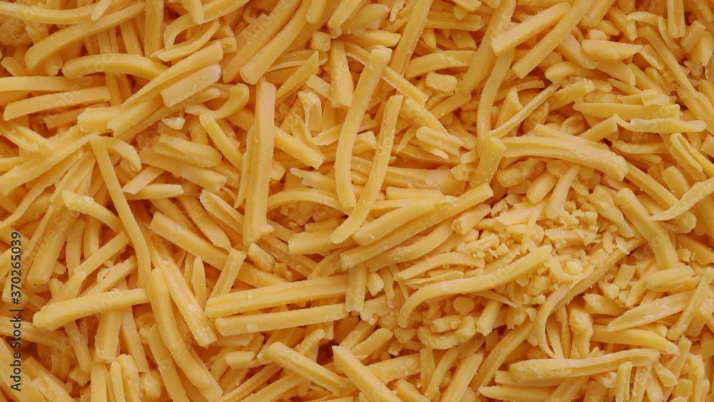 Closeup of Rotating shredded Cheese Closeup of Rotating shredded Cheese