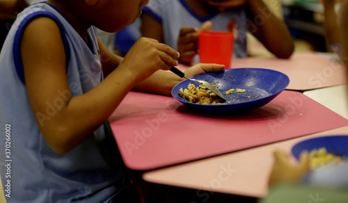 salvador, bahia / brazil - march 22, 2019: child is seen eating school lunch in criche in the city of Salvador. photo