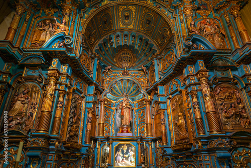 Chapel interior in the Lima Metropolitan Cathedral with Virgin Mary and baby, a baroque style altar in wood (blue and gold decorations), Lima, Peru.