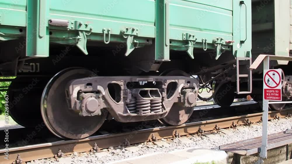 freight train moving slowly across a small bridge. close-up plan. freight train moving slowly across a small bridge. close-up plan.