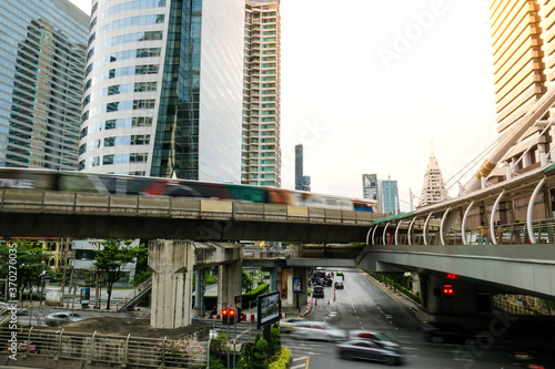 BTS sky train runs through the station. View of Bangkok skyline and skyscraper with BTS skytrain. © PhetcharatBiRTH