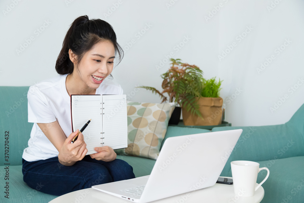 Beautiful freelancer female talking on video conference online with laptop at home. Study on online distant course. Talk on video call with friend or relative. Beautiful freelancer female talking on video conference online with laptop at home. Study on online distant course. Talk on video call with friend or relative.