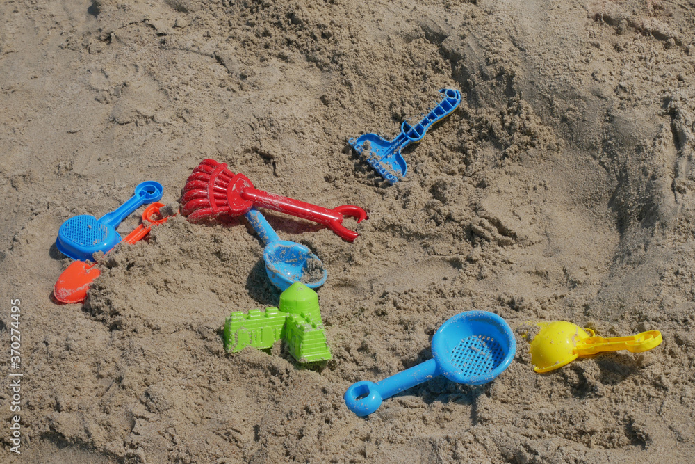 Some beach toys are made of plastic scattered randomly on the beach sand. Abandoned by children.
Some beach toys are made of plastic scattered randomly on the beach sand. Abandoned by children.