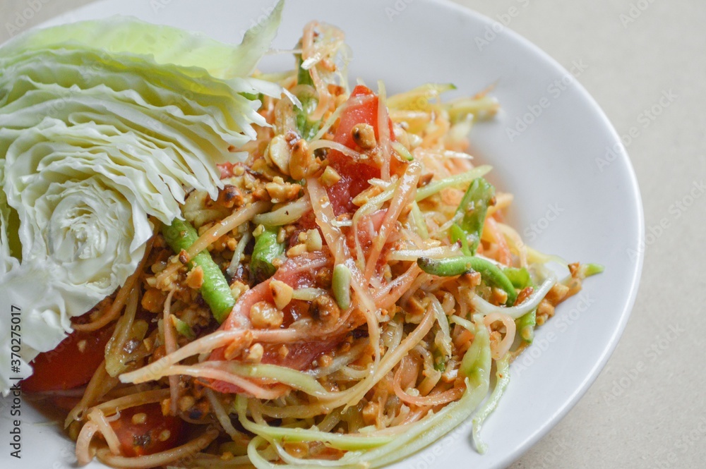 spicy papaya salad on wood floor - Thailand healthy food spicy papaya salad on wood floor - Thailand healthy food