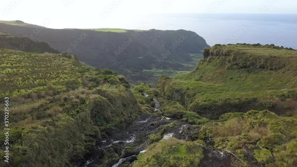Aerial Tilt Shot Of Riberia Grande Waterfall Cascading Down Cliffside, Azores
