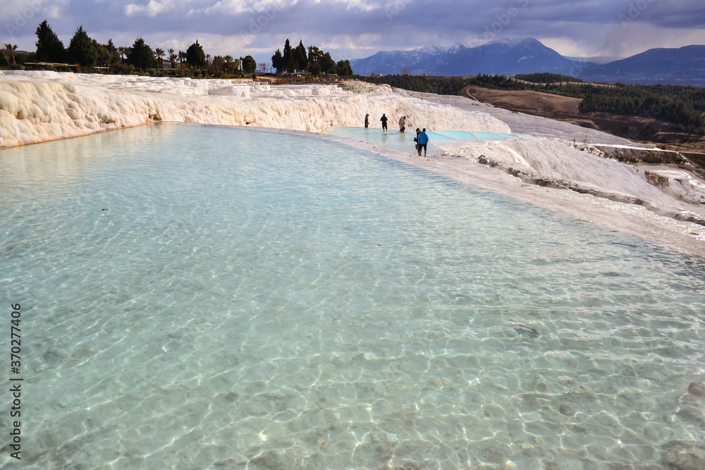 spectacular landscape of white stone pools made by carbonate mineral left by the hot flowing waters and turquoise hydrothermal waters