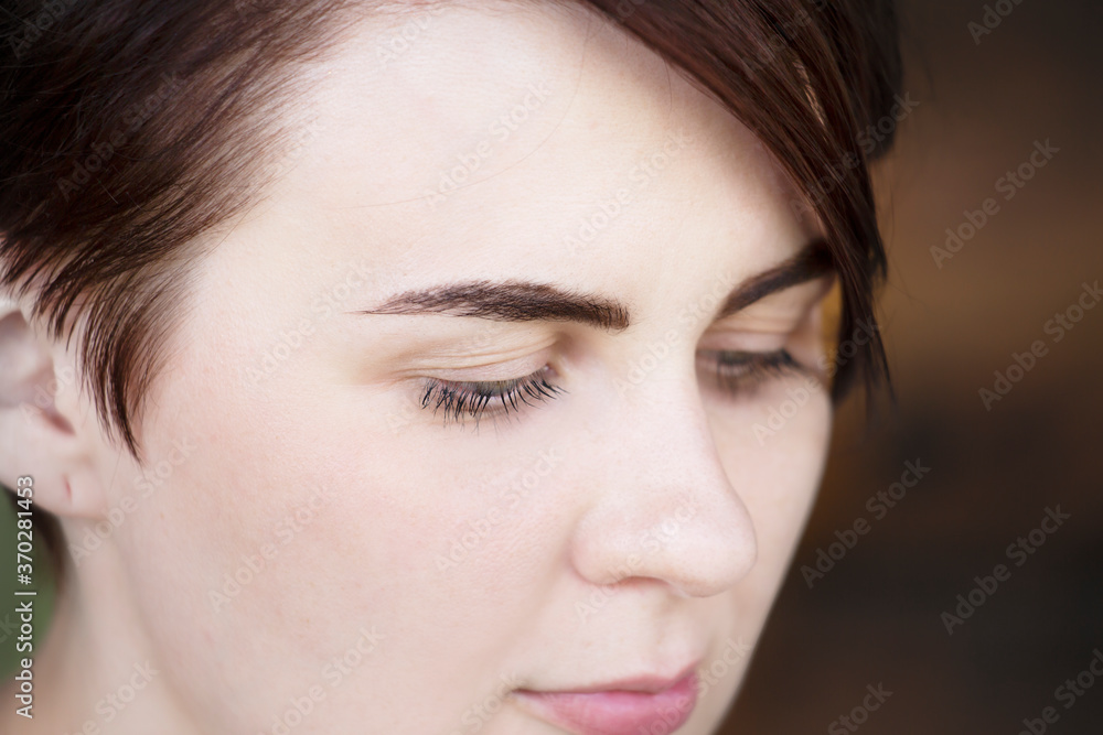 Portrait of a beautiful girl with lowered lashes Portrait of a beautiful girl with lowered lashes