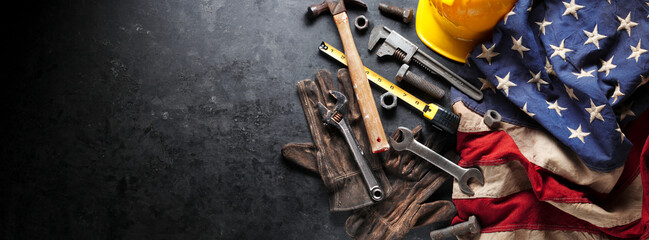 Construction and manufacturing tools with patriotic US, USA, American flag on dark black background