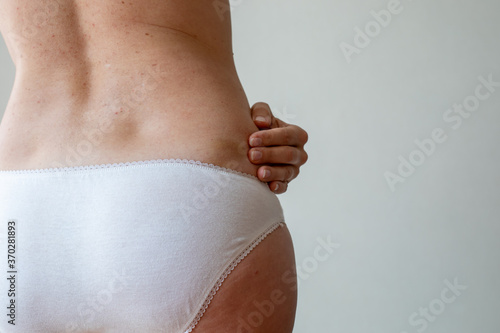Photos Hand pointing to bruises after massage or injection or beatings on white skin woman's loins