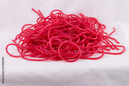 Candy pile of delicious red Strawberry laces - flavoured licorice sweetshop treat
