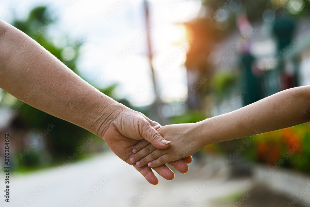 Nature a parent holds the hand of a small child Nature a parent holds the hand of a small child