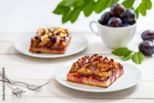 Fresh plum cake on a wooden table photo