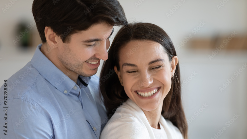 Close up head shot affectionate loving family couple newlyweds enjoying romantic sweet moment together indoors. Happy young devoted soulmates showing tender feelings, good relations concept. Close up head shot affectionate loving family couple newlyweds enjoying romantic sweet moment together indoors. Happy young devoted soulmates showing tender feelings, good relations concept.