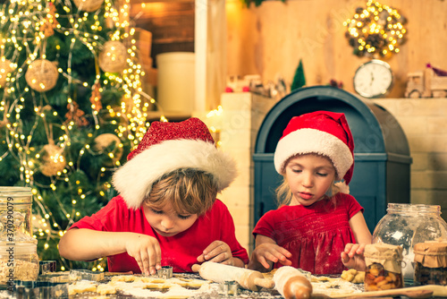 Thanksgiving day and Christmas for children. Two cute boys with santa hat. Merry Christmas. Christmas food and drink. Cookies for Santa Claus.