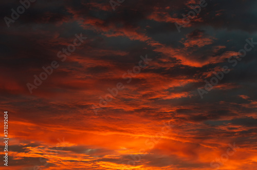 Dramatic sky with clouds gradient from black at the top to yellow-orange at the bottom during sunset © Dmitriy Os Ivanov