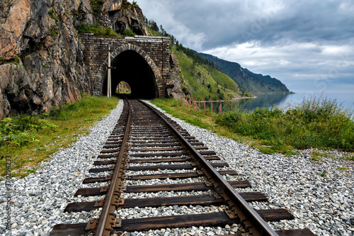 Circum-Baikal old railway with tunnel on summer cloudy day