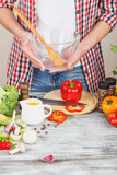 Woman cooks at the kitchen, soft focus background