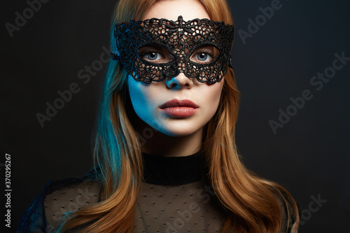 Beautiful young Woman in Mask. Color Lights