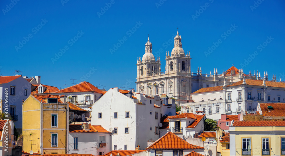 Lisbon skyline on a sunny day with colorful facades, rooftops and Saint Vincent monastery in the background 