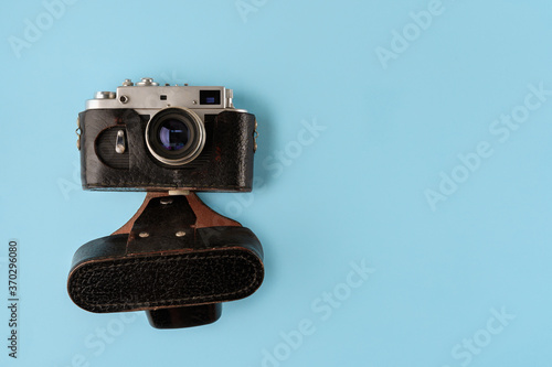 Retro photo camera on blue background, top view photo