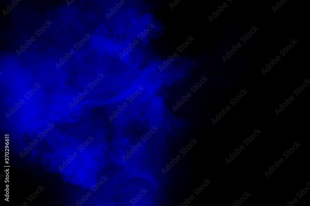 Abstract blue  powder explosion cloud  on dark background.