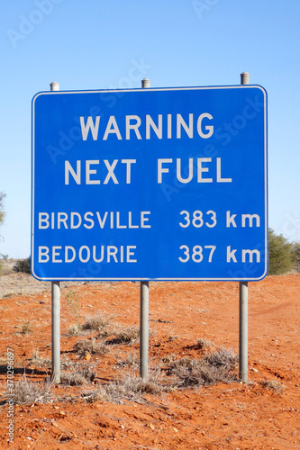 Warning fuel sign beside the road in outback Queensland, Australia photo