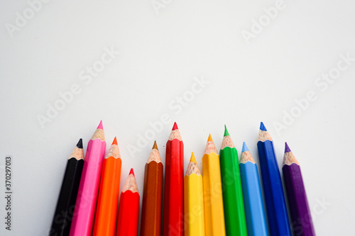 The cropped shot view of color pencils with white background, blank copy space screen for your text message or information content.