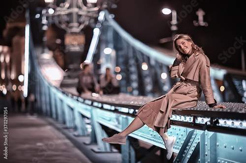 girl in a coat, spring glance, night walk in budapest chain bridge landscape