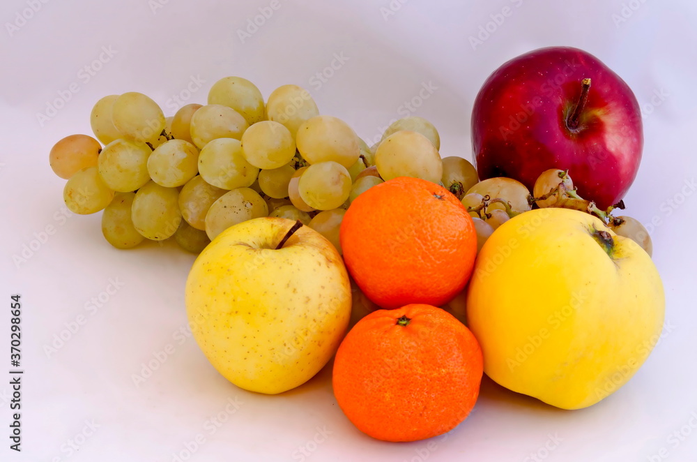 Group of different fresh ripe fruits - apple, quince, grapes and oranges, Sofia, Bulgaria Group of different fresh ripe fruits - apple, quince, grapes and oranges, Sofia, Bulgaria