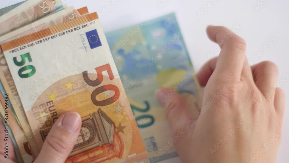 White caucasian woman counting euro money banknotes White caucasian woman counting euro money banknotes